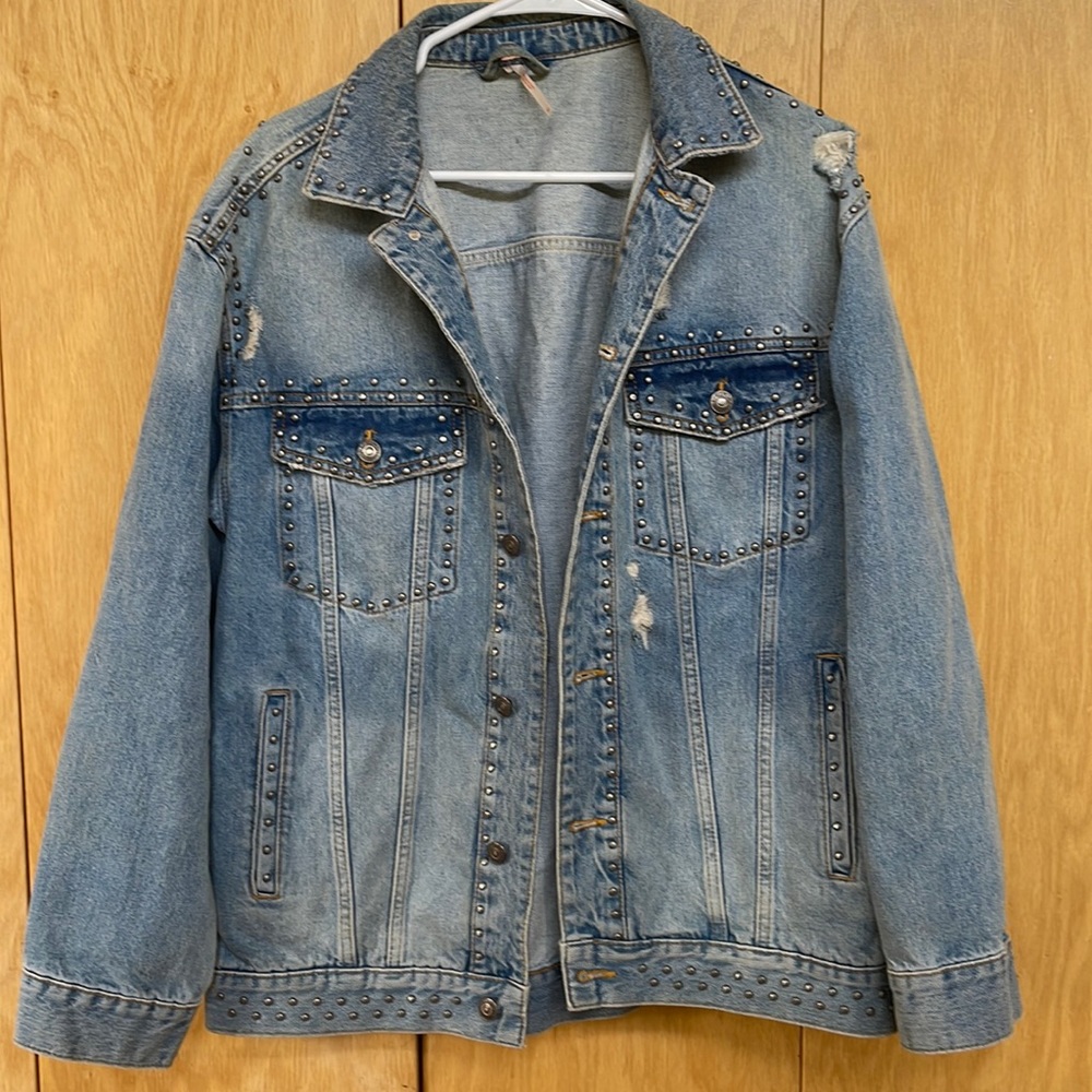 Free People blue jean jacket, with gray studs, and random torn areas, medium